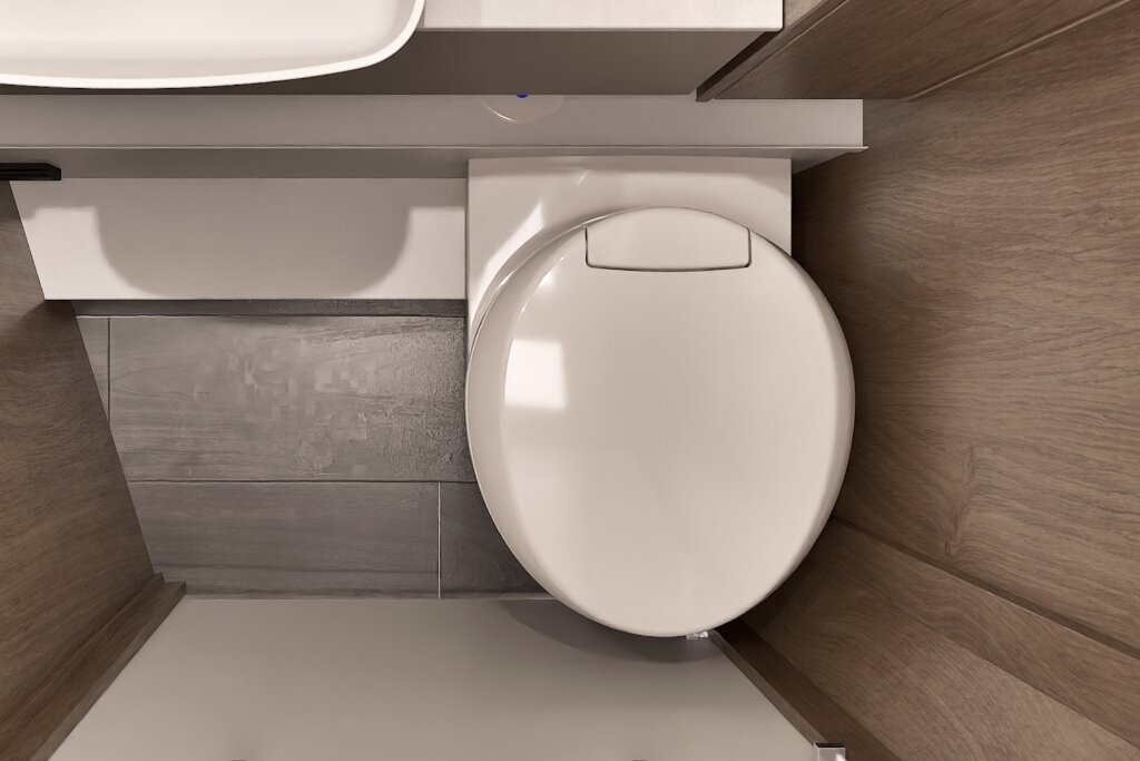 Carado motorhome bathroom with cassette toilet, wood-look finish and grey flooring