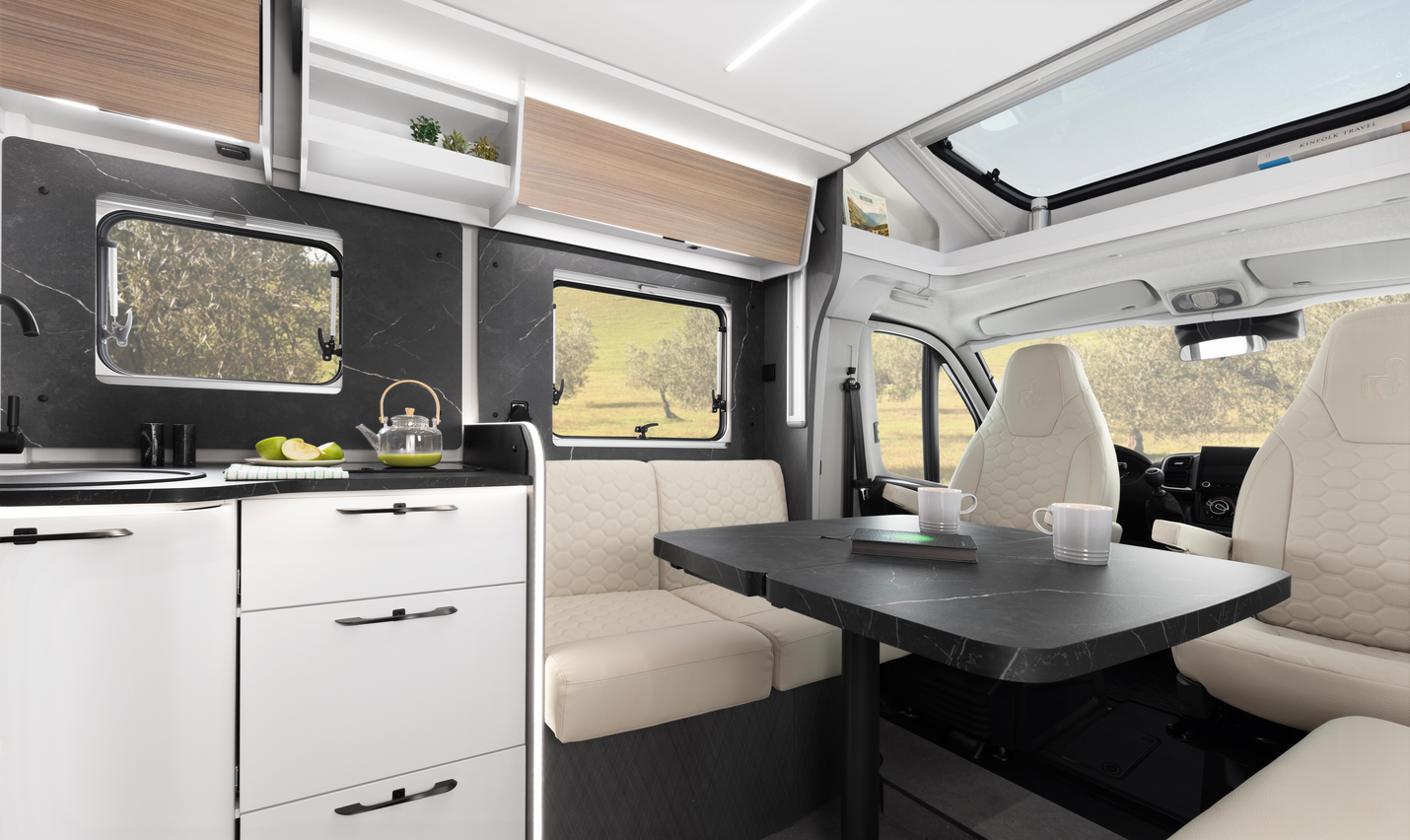 Kitchen area of an Etrusco semi-integrated Fiat motorhome with stainless steel sink, closed gas stove, and daylight through a window.