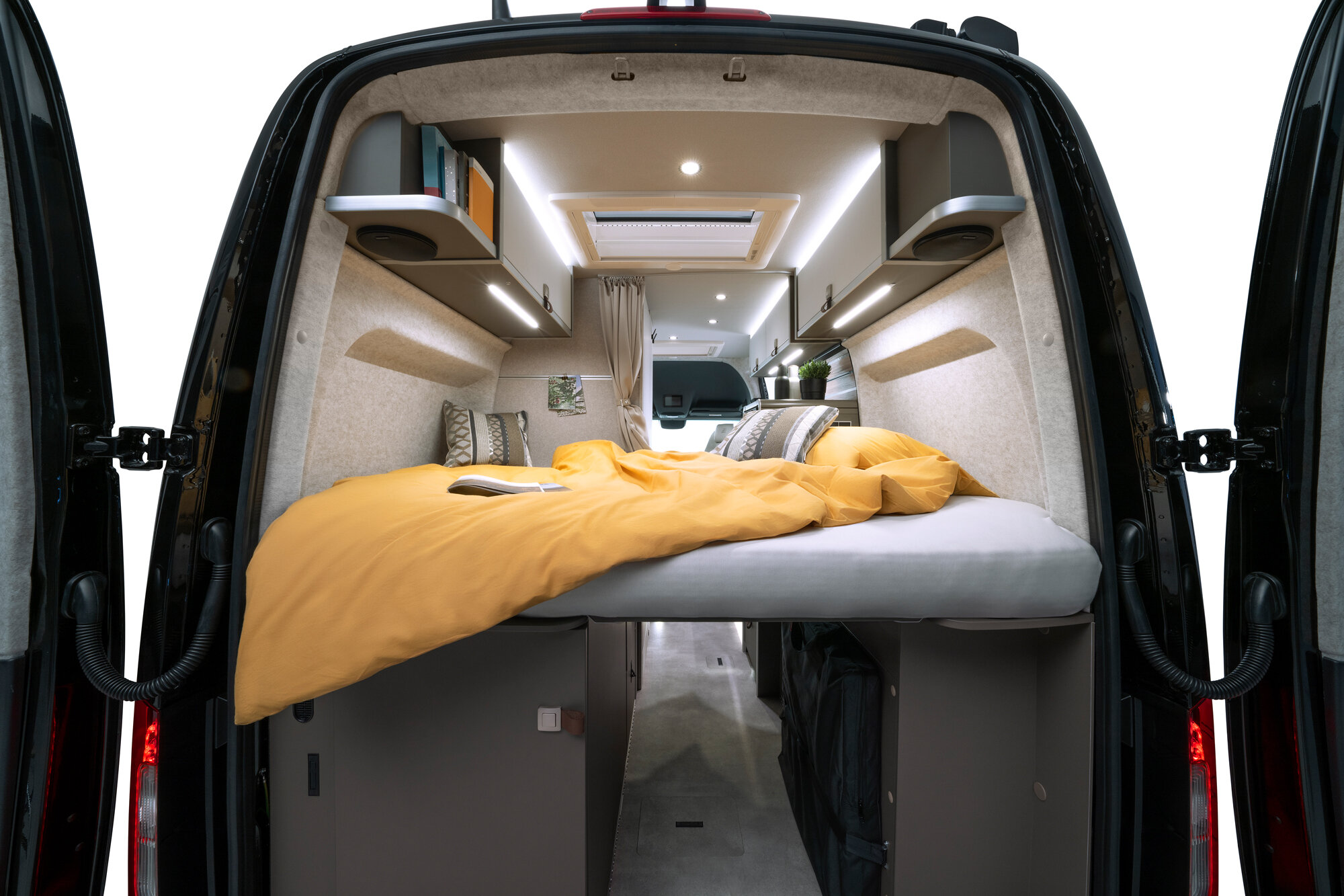 In the evening, unroll the mattress and make the most of the large bed at the rear of the camper van.