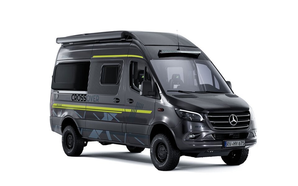 Oblique side view of a dark camper van with neon green side decals, dark tires with black rims, and a black awning, a LED light bar is mounted above the windshield