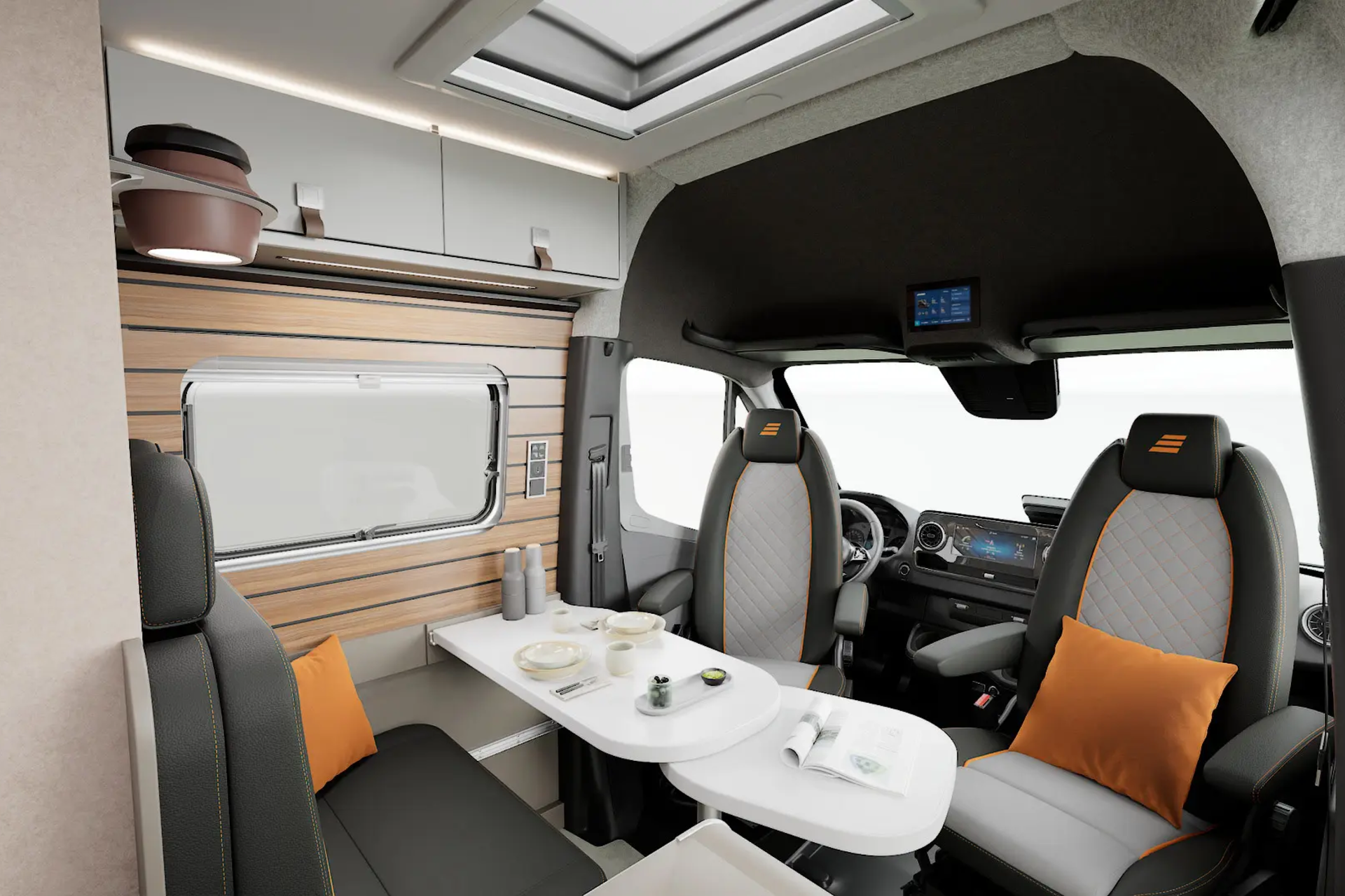 The living area of the HYMER Grand Canyon S in the Pearl Grey style world photographed from the passenger seat.