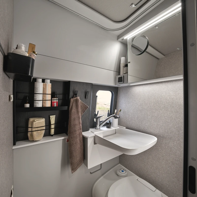 In the compact bathroom of the HYMER Grand Canyon S in the Pearl Grey style world, there are numerous storage options for your toiletries.