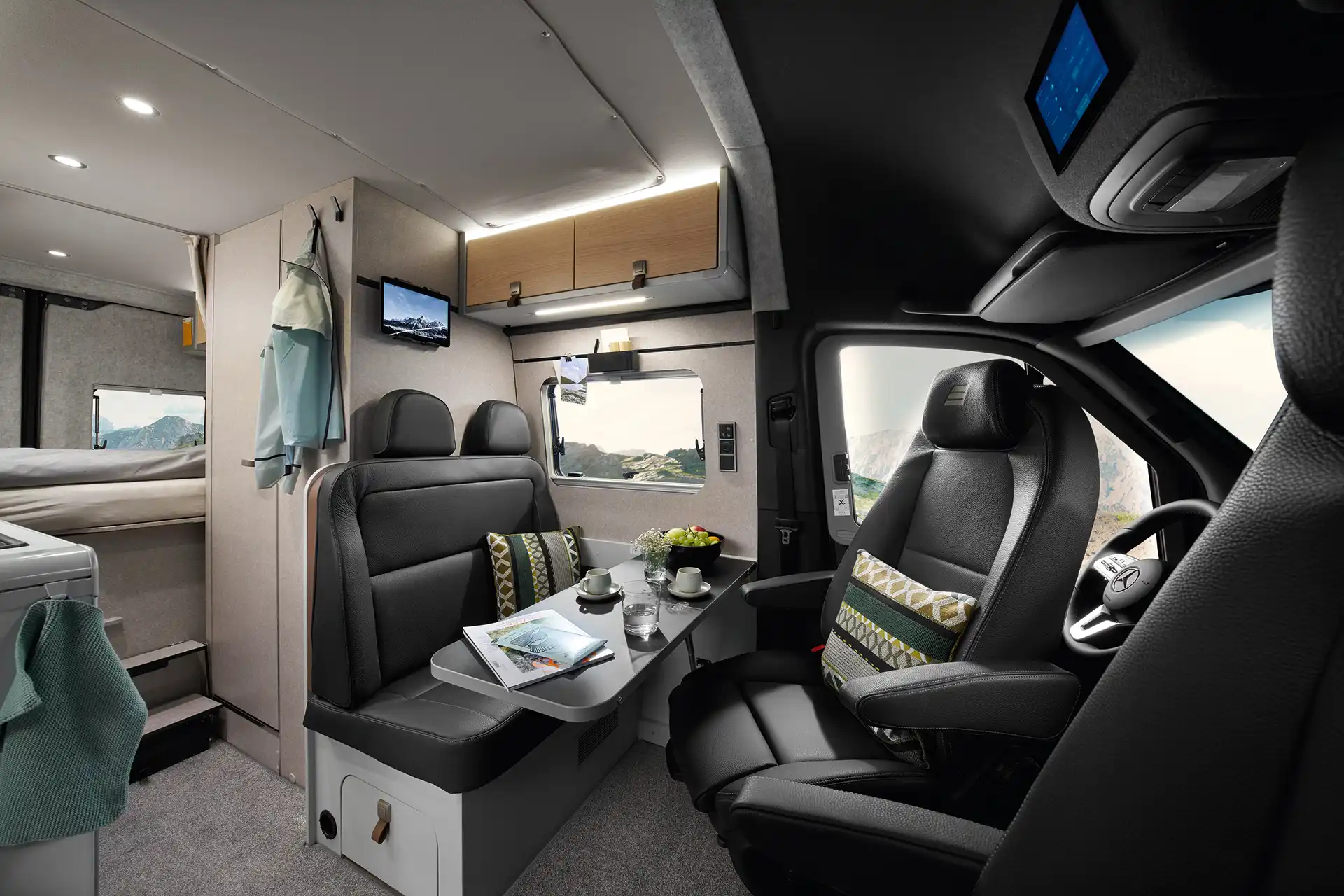 The living area of the HYMER Grand Canyon S in the Pearl Grey style world photographed from the passenger seat.