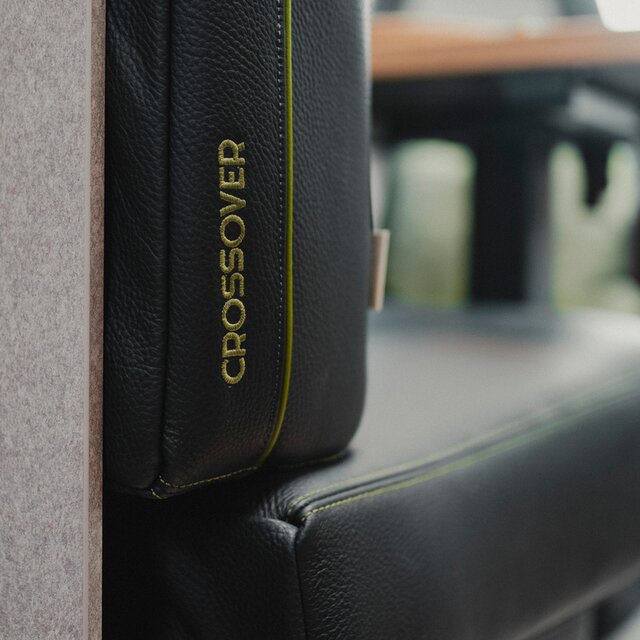 Black leather upholstery with green stitching and CrossOver lettering embroidered in green
