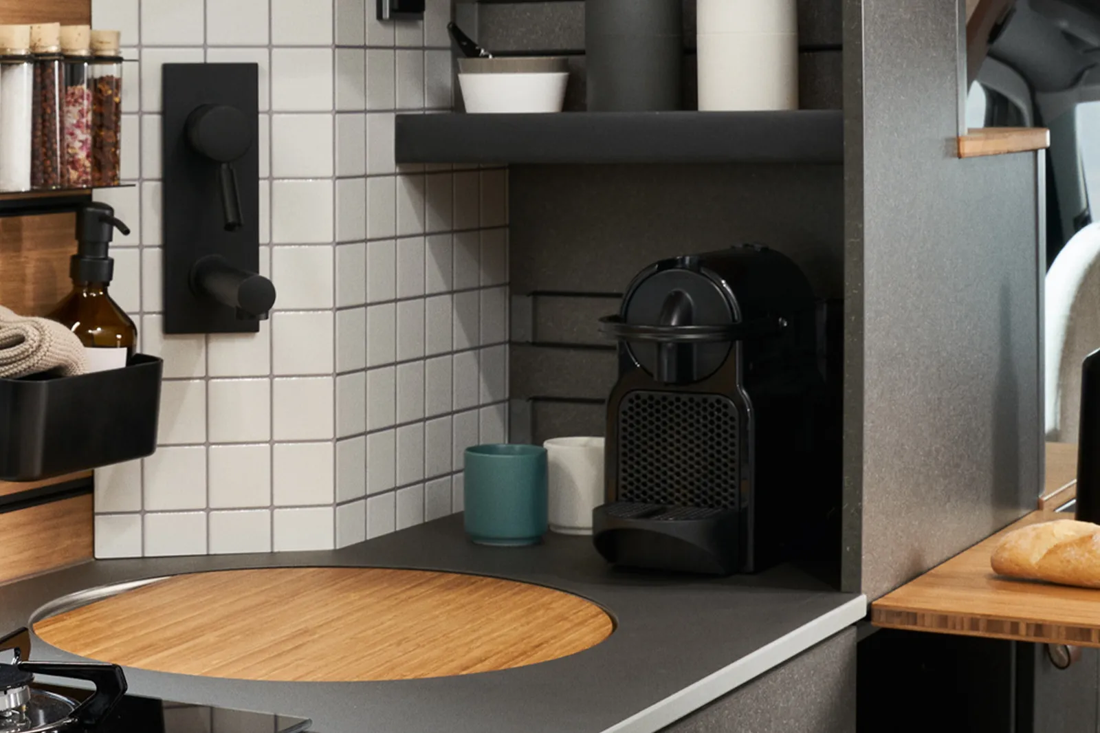 A small espresso machine is in a niche next to the faucet in the Venture.